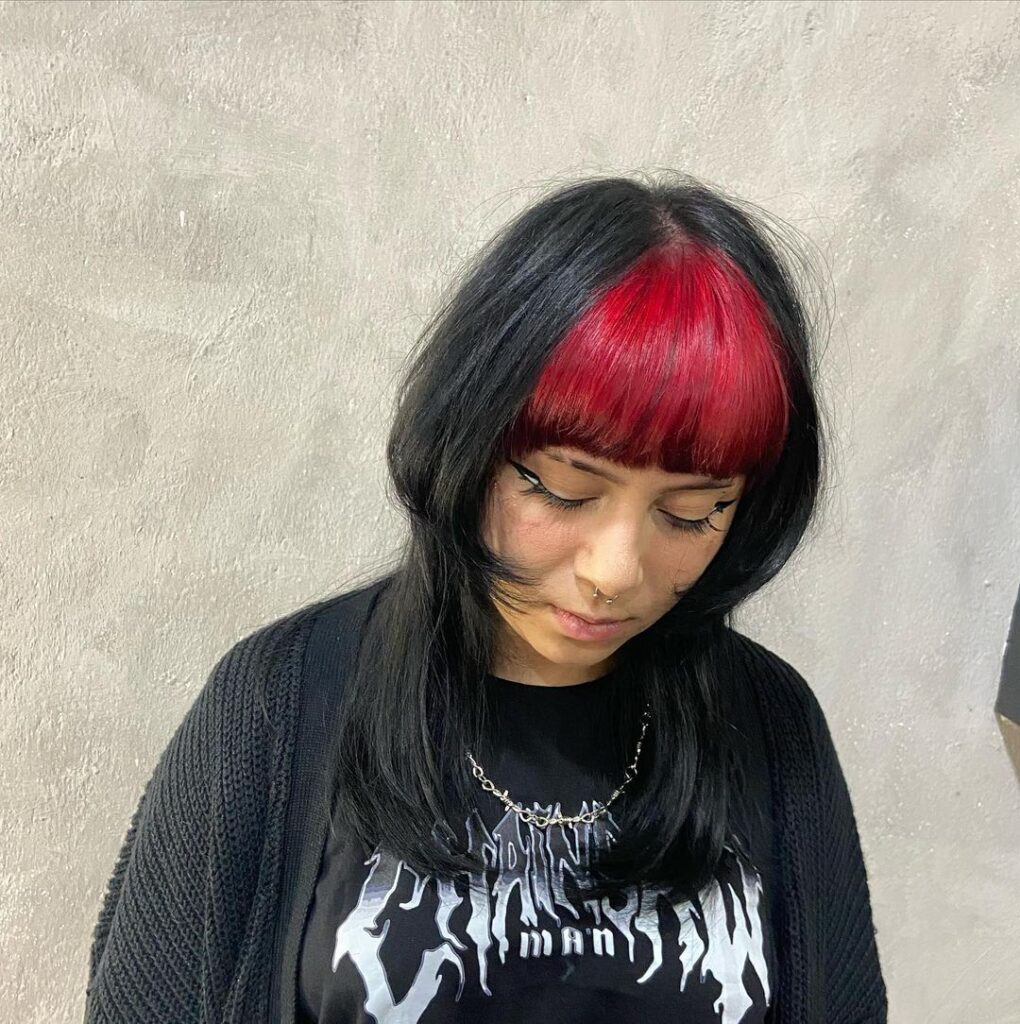 black jellyfish haircut with red bangs