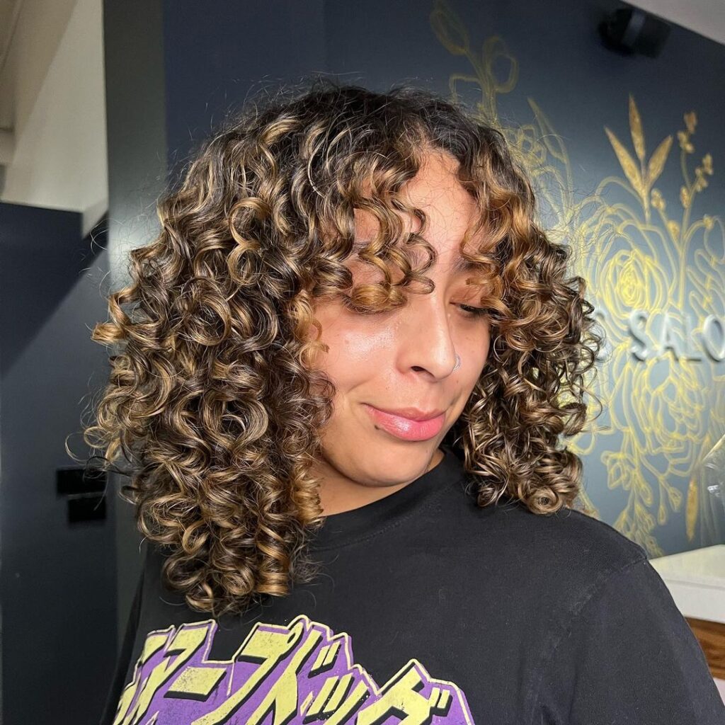 buttery caramel highlights on curly hair