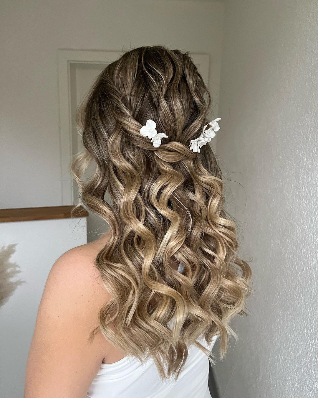 curled hair with flower piece