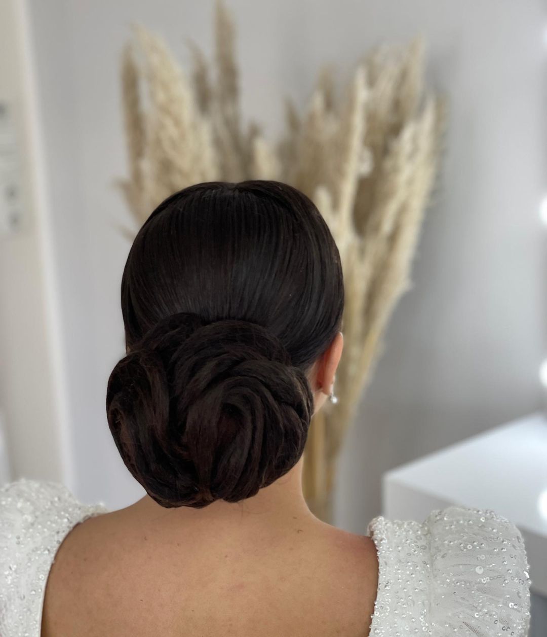 rose shaped low bun wedding hairstyle