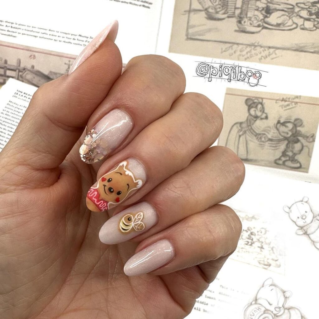 winnie on gold nude nails