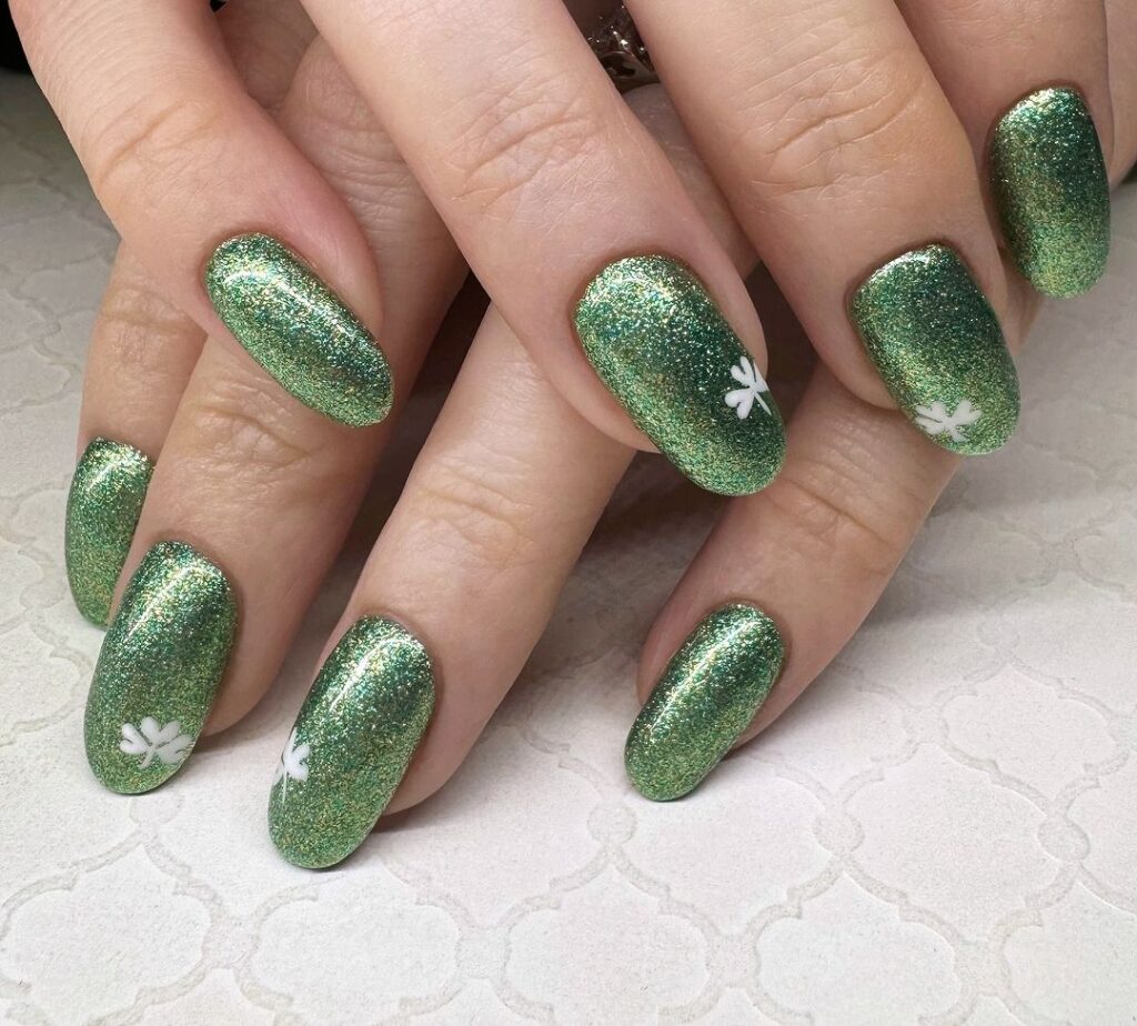green and gold glitter and white clover nails