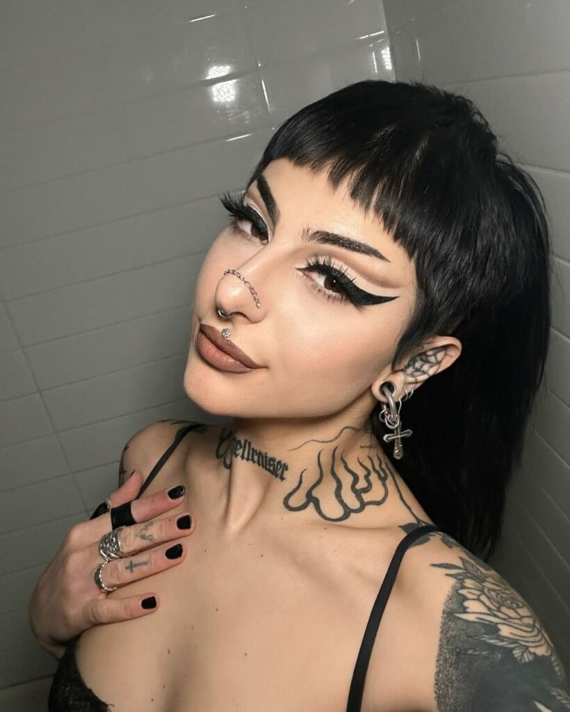 black winged eyeliner and nude lips clean goth makeup