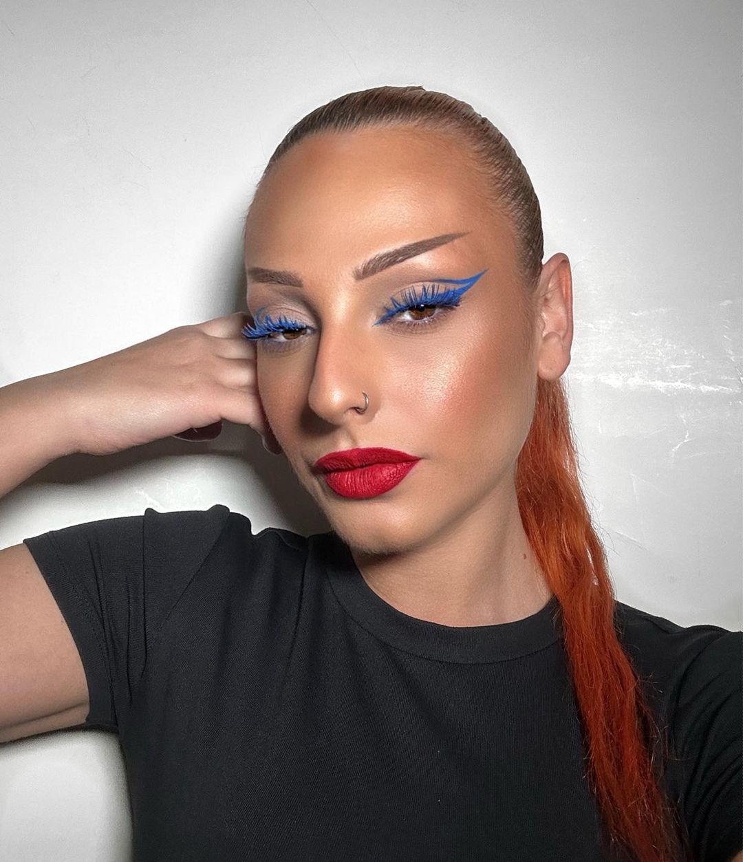 glam red lip with royal blue eye makeup