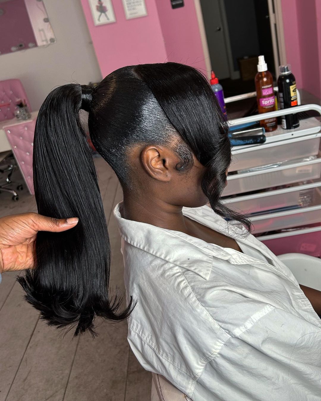 sleek ponytail with a swoop bang