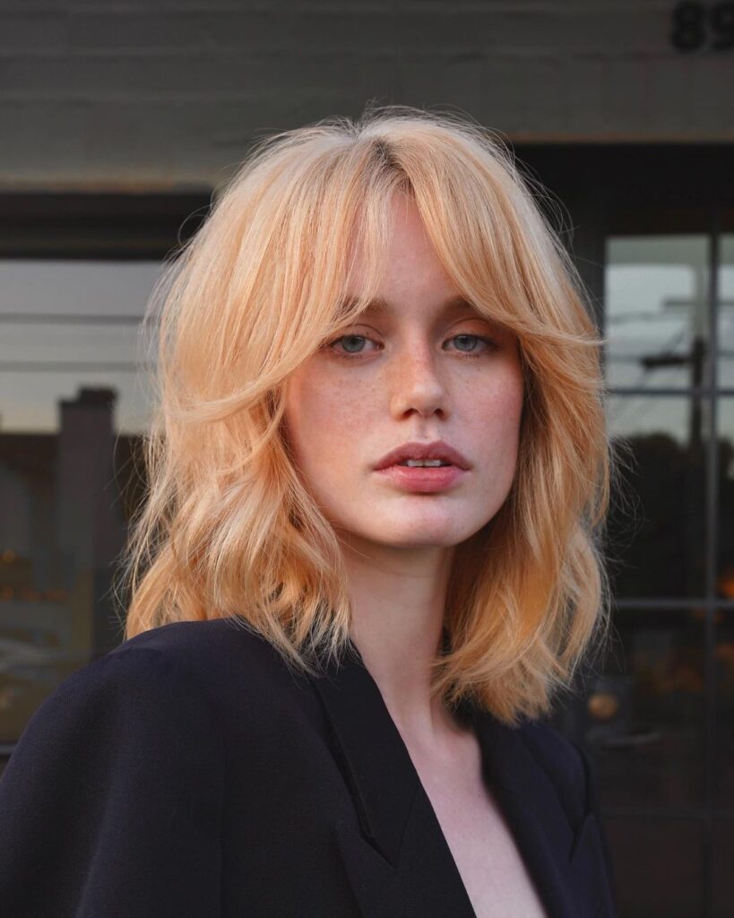 strawberry blonde shaggy lob with bangs