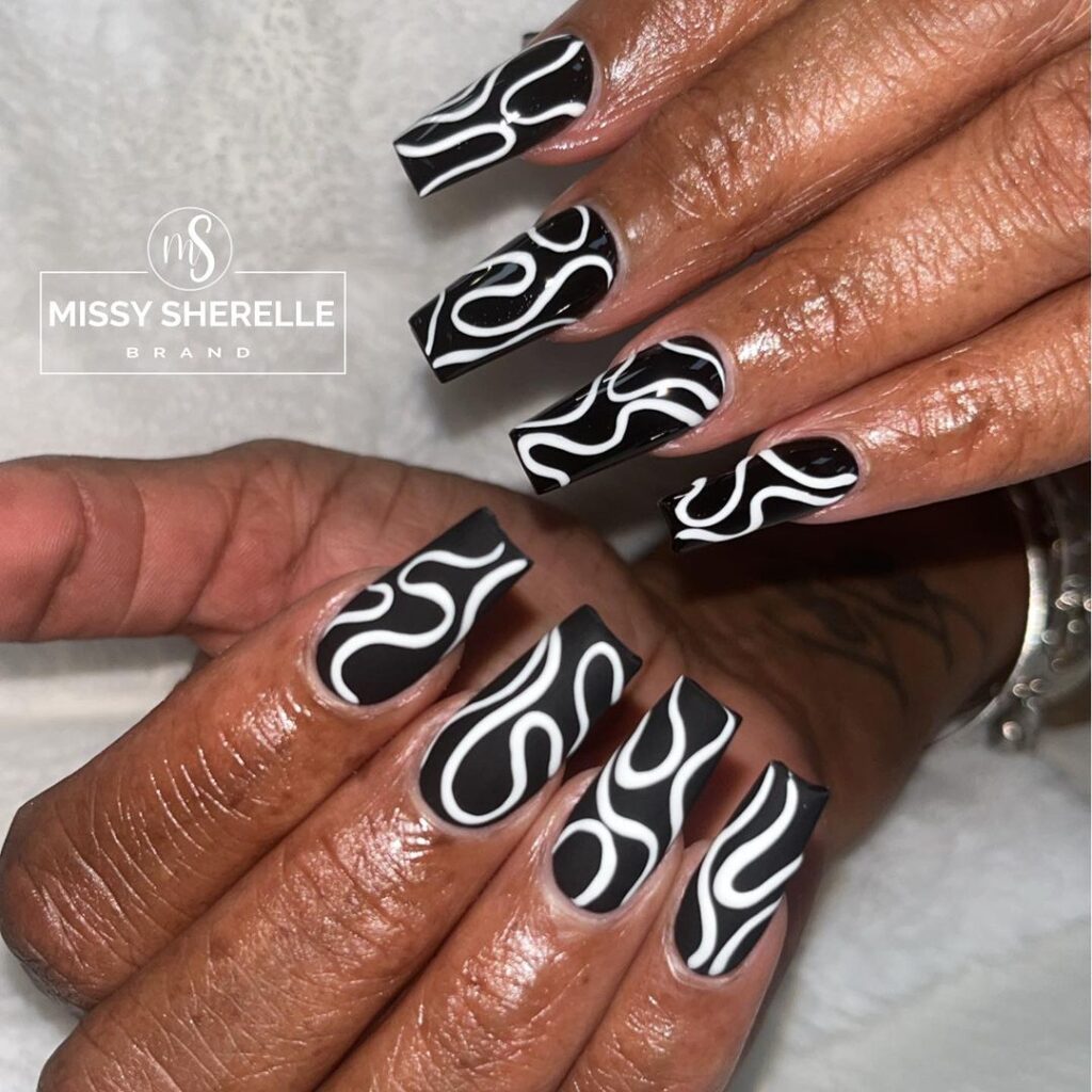 white swirls on black base nails