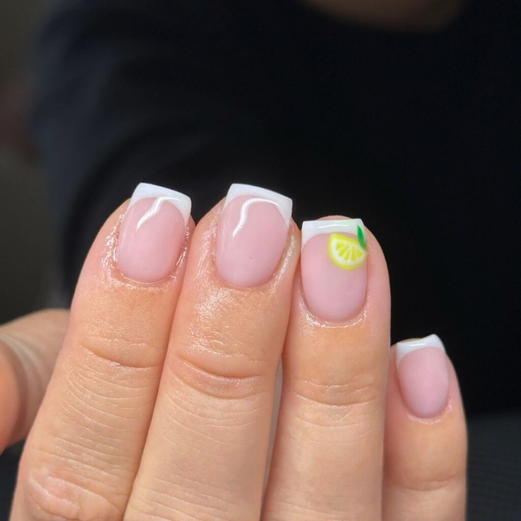 classic french manicure with subtle lemon art