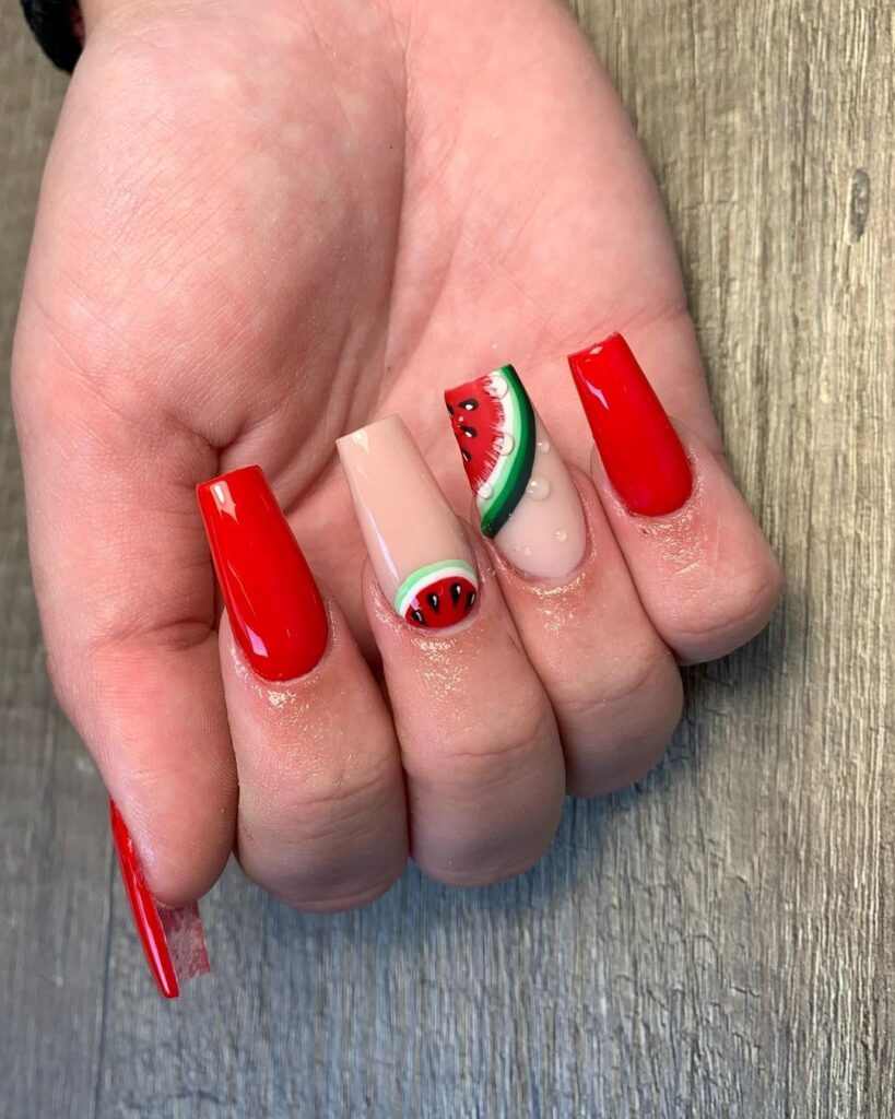 slices of watermelon on red nails