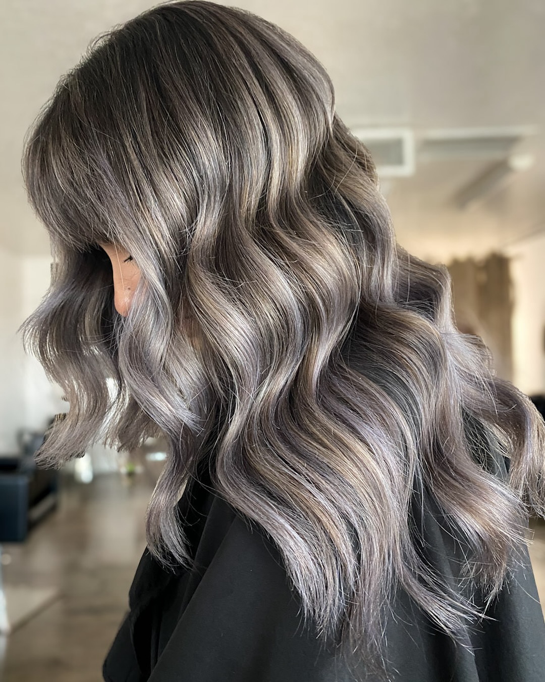 silver lights with bangs wavy hairstyle