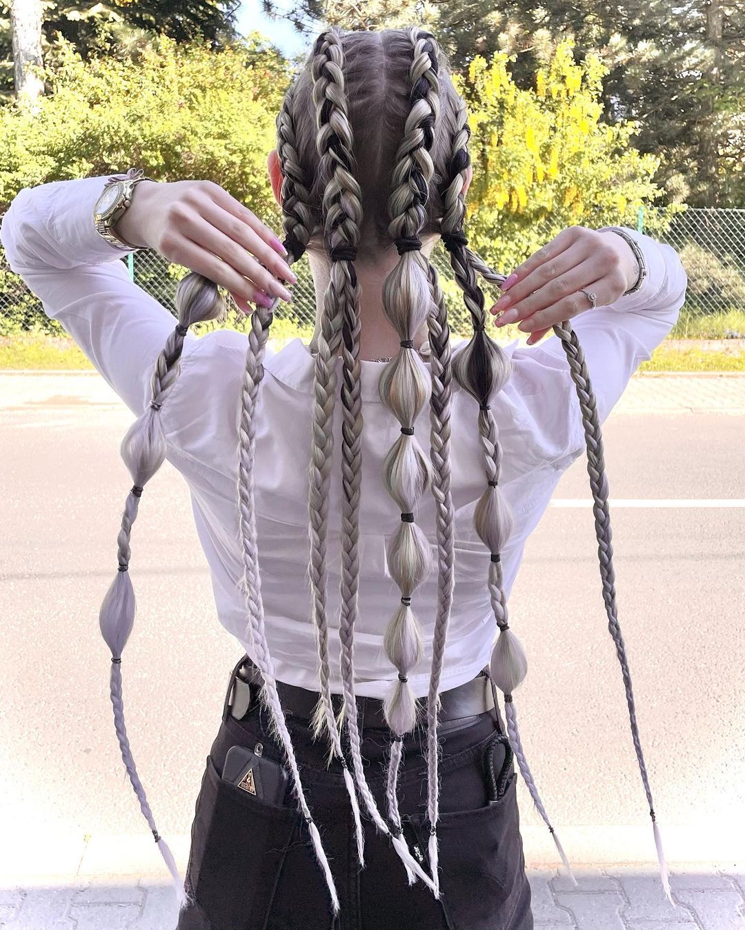 waist length multiple braided ponytails 