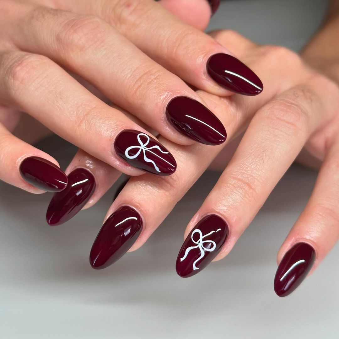 an ode to a bow burgundy nails