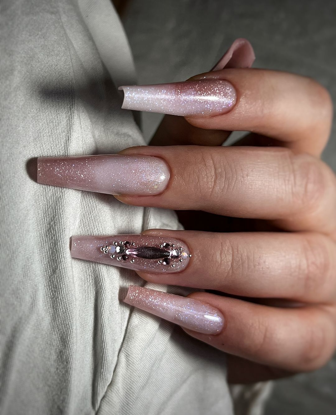 cosmic queen nude glitter nails