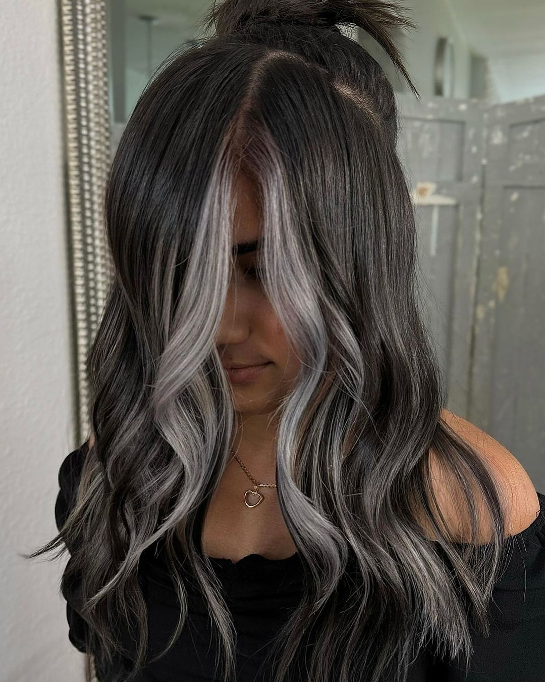 dark hair with silver face framing highlights