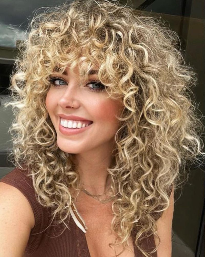 Voluminous Curls with Wispy Bangs